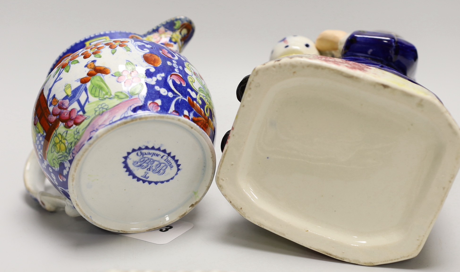 A pair of Derby plates, c.1820, an opaque china jug and a Toby jug. Tallest 24.5cm